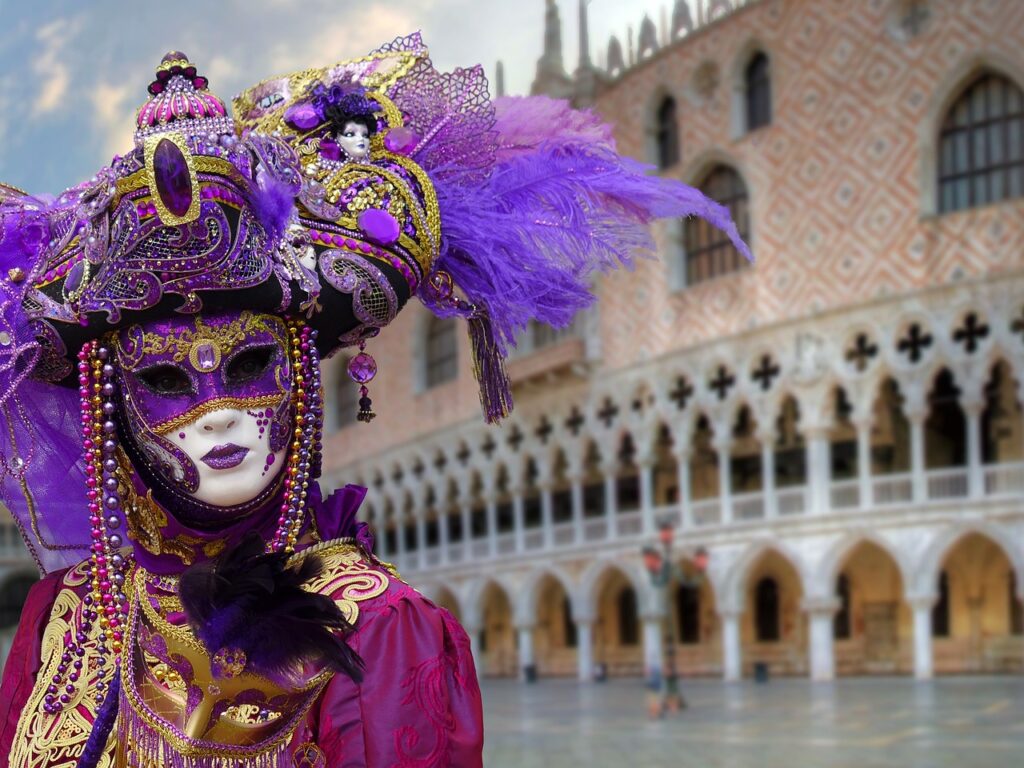 Carnevale: una tipica e raffinata maschera veneziana con, alle spalle, il Palazzo Ducale